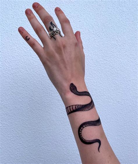 snake tattoo around wrist